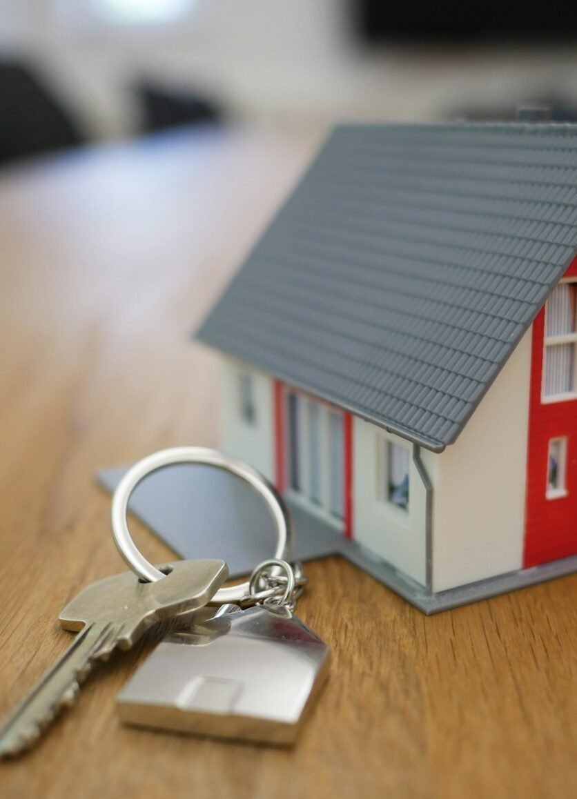 white and red wooden house miniature on brown table
